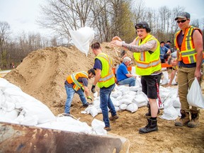 Water levels came down slightly in Ottawa's Constance Bay neighbourhood on Sunday, May 7, 2023. Volunteers and city crews were at the Constance and Buckham's Bay Community Centre helping fill sandbags and load them to go to flooded areas.