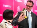 Ginette Petitpas Taylor, the federal minister of official languages, presents a stuffed peregrine falcon to Jean-François Roberge, the Quebec French language minister, during their luncheon get-together at the Montreal Chamber of Commerce on Monday May 8, 2023.