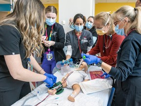 A multidiscipline team attends to a baby during a simulation of a child experiencing an allergic reaction, staged during the opening of the Centre for Pediatric Simulation at the Montreal Chidren's Hospital on Wednesday, May 10, 2023.