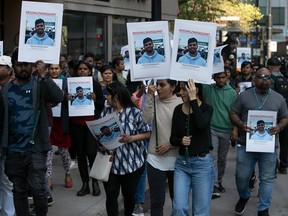 Protesters walk along Guy Street to show support for missing Montrealer Sridhar Nidammanuri on Wednesday May 10, 2023.