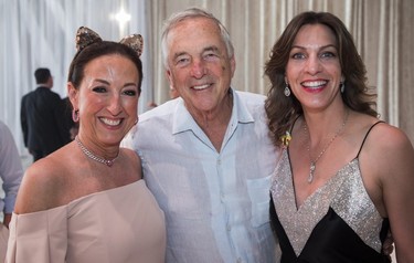 Herbert Black, president & CEO of American Iron & Metal Company Inc with his wife ,Véronique Black (right), a co-chair of the Partnership Committee of the Bal des Tannants for The Children's, and Renée Vézina, president, The Montréal Children's Hospital Foundation, at the Bal des Tannants for the Children's in the Dorval area of Montreal on Friday, May 12, 2023. The event, in which guests were invited to show up with childish accents in their dress as a way to let their 'inner brats' show, was put on by the Montreal Children's Hospital Foundation and held in Starlink Aviation's hangar.