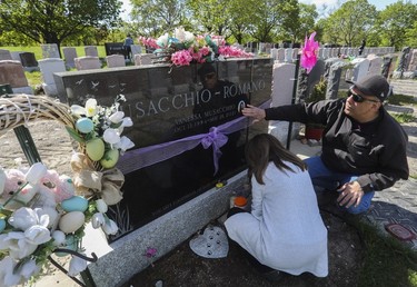 Antoinette Romano, with her husband Michael Musacchio, visit the gravesite of their daughter Vanessa, who died in 2021, at Notre-Dame-des-Neiges Cemetery on May 14, 2023.