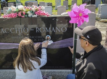 Antoinette Romano, with her husband Michael Musacchio, cleans the gravestone of their daughter Vanessa, who died in 2021, at Notre-Dame-des-Neiges Cemetery on May 14, 2023. Part of the cemetery briefly reopened for Mother's Day.
