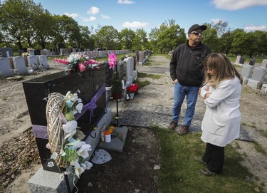 Michael Musacchio and his wife Antoinette Romano visit the gravesite of their daughter Vanessa, who died in 2021, at Notre-Dame-des-Neiges Cemetery on May 14, 2023. Part of the cemetery briefly reopened for Mother's Day.
