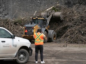 Members of the Montreal media get first-hand look at a front loader pushing branches from the April ice storm into stacks of wood at the St-Michel Environmental complex May 15, 2023.