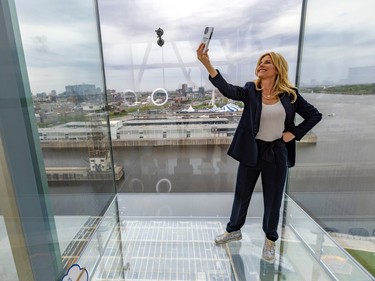 Actress Julie duPage takes a selfie in the glass cage 55 metres up at the Port of Montreal Tower on Monday May 15, 2023. She was there to be the mistress of ceremony for the event prior to its inauguration.
