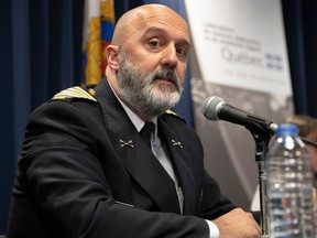 Pierre Duquette in uniform at a microphone