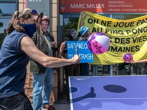 Masked protesters play ping pong