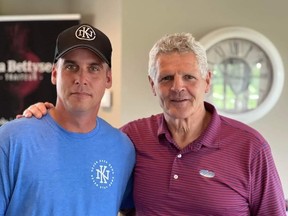 Kevin Reason stands with Chris Nilan