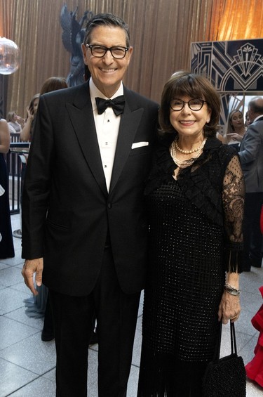A couple poses for a photo at a black-tie event