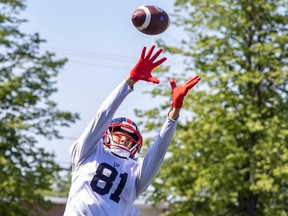Austin Mack reaches for a football flying above his head