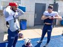 James Letcher, left, and Tyson Snead put on their shoulder pads during Alouettes training camp practice in Trois-Rivières this week.