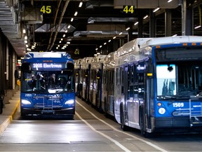 blue electric buses at an STL garage