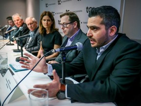 Andrew Mulé of Métro Média, right, defends the Publisac along with union leaders and publishers during a news conference in 2019.