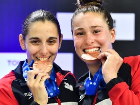 Pamela Ware of Greenfield Park and Mia Vallée of Beaconsfield pose with their bronze medals after finishing third in the Women's Synchronized 3m Springboard Final during the World Aquatics Diving World Cup 2023 at the Olympic Park Sports Centre on Friday, May 5, 2023, in Montreal.