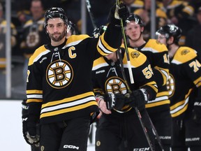 Patrice Bergeron waves to fans before exiting the ice after the Florida Panthers defeat the Bruins 4-3 in overtime of Game Seven of the first round of the 2023 Stanley Cup Playoffs at TD Garden on April 30, 2023 in Boston, Mass.