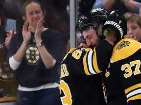 Patrice Bergeron #37 of the Boston Bruins hugs Brad Marchand #63 before exiting the ice after the Florida Panthers defeated the Bruins 4-3 in overtime of Game 7 of the First Round of the 2023 Stanley Cup Playoffs at TD Garden on April 30, 2023 in Boston.