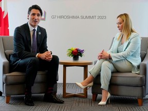 Prime Minister Justin Trudeau, left, delivers opening remarks at the start of a bilateral meeting with Italian Prime Minister Giorgia Meloni at the G7 Summit in Hiroshima, Japan, on May 19.