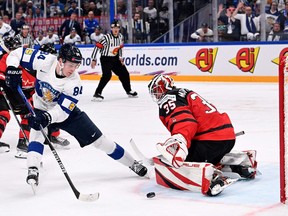 Canadian goalie Sam Montembeault stymies Finnish forward Kaapo Kakko.