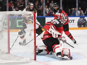 A goaltender in a Team Canada uniform makes a save against Germany