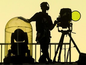 A spotlight operator in silhouette