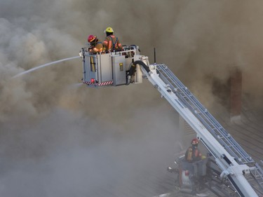 Firefighters combat the major blaze at the former Monastère du Bon Pasteur in Montreal on May 26, 2023.