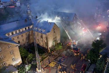 Firefighters combat a major blaze at the former Monastère du Bon Pasteur in Montreal on May 25, 2023.