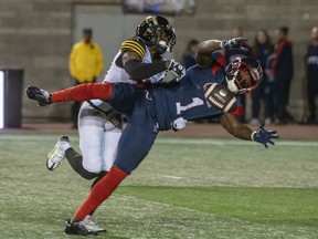 Montreal Alouettes' Hergy Mayala misses the catch as he is covered by Hamilton Tiger-Cats' Richard Leonard during second half CFL football action in Montreal on September 23, 2022.