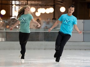 Joannie Rochette and Patrick Chan skate together wearing promotional T-shirts