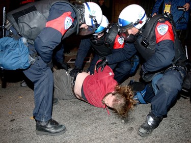 An anti-monarchy protester is detained by police near the Black Watch armoury, during a visit by Prince Charles and Camilla, Duchess of Cornwall, in 2009.