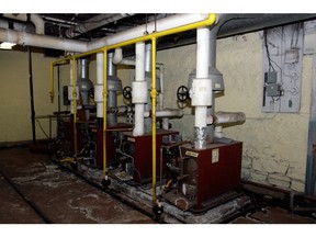 Four old furnaces in a basement.