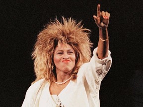 Tina Turner points while performing on stage