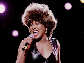 Tina Turner sings into a microphone