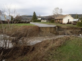 A neighborhood is cut off from the city as a flooded river took out the bridge on Monday, May 1, 2023 in Baie-Saint-Paul, Quebec.
