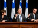 Quebec Premier François Legault, flanked by Immigration Minister Christine Fréchette, left, and Minister of the French Language Jean-François Roberge, presents new programs on immigration at a news conference Thursday, May 25, 2023 at the legislature in Quebec City.