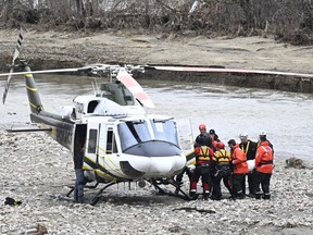 Rescuers carry the body of one of the two missing firefighters to a helicopter, Wednesday, May 3, 2023 in Baie-Saint-Paul. The coroner's office has formally identified the two volunteer firefighters who were killed during the recent flooding in Quebec's Charlevoix region.
