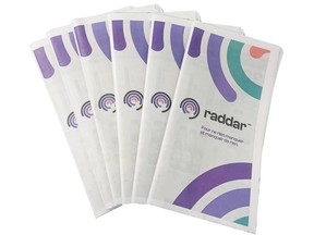 A stack of newsprint flyers with the name "Raddar" on the cover