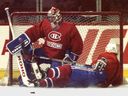 Canadiens rookie Craig Conroy slides into goalie Patrick Roy during practice at the Montreal Forum in 1995.