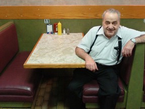 Peter Varvaro Sr., owner of the Main Deli on St-Laurent, takes a seat just after midnight in Montreal Sunday, March 25, 2007.