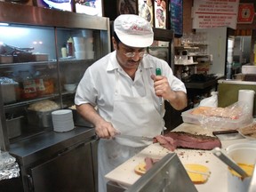 Slicing smoked meat at the Main Deli just after midnight in 2007.