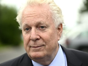 Former Quebec premier Jean Charest is demanding another $700,000 from the provincial government for media leaks related to a corruption investigation targeting him and his former Liberal party. Charest speaks to reporters in Ottawa, on Wednesday, Aug. 3, 2022.