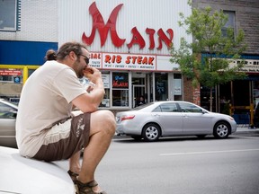 Pier Paul Micheletti enjoys a smoked meat sandwich on St-Laurent Blvd. across from the Main Deli in 2008.