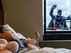 Siena Di Niro, 4, who is recuperating from hip surgery got a surprise visit from Batman, a.k.a. Fabian de Colman, who was cleaning the windows at the Shriners Hospitals for Children at the MUHC in Montreal on Thursday May 4, 2023. Last year, de Colman showed up in his regular work clothes, but felt bad he decided this year to dress up in costume.