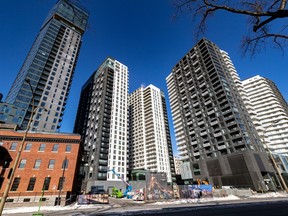Several high rise condo buildings against a blue sky