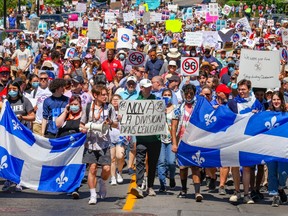 Demonstrators walk down Atwater St. during rally to oppose Bill 96 in Montreal Saturday May 14, 2022.