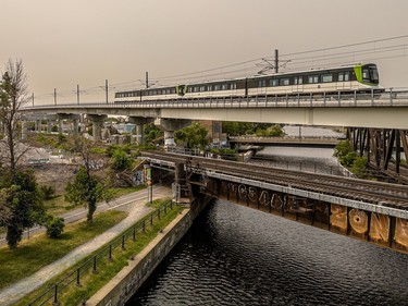 an rem train over the canal and under hazy skies from forest fires