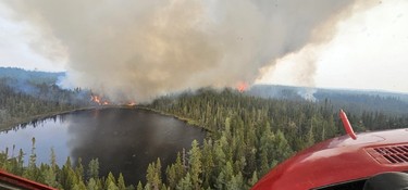 aerial view of a forest fire and smoke rising in northern ontario