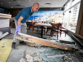 Monkland Grill owner Mohammad Ebrahim Jahanian cleans up on Thursday, June 8, 2023 after a car crashed into the facade of his Somerled Ave. establishment the day before.