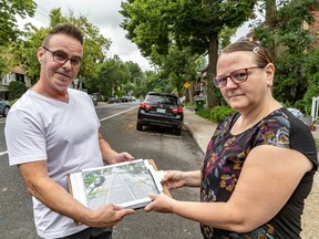 Eddy Moura and Julie Hubert hold an image showing the redesigned road