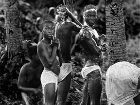 Haitians look at the camera at a watering hole